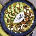 Roasted Pumpkin–Potato-Parsnip Velouté Bowl with Mushrooms, Tomato, Avocado & Poached Egg as topping, decorated with Goggi berries, nuts and black cumin.