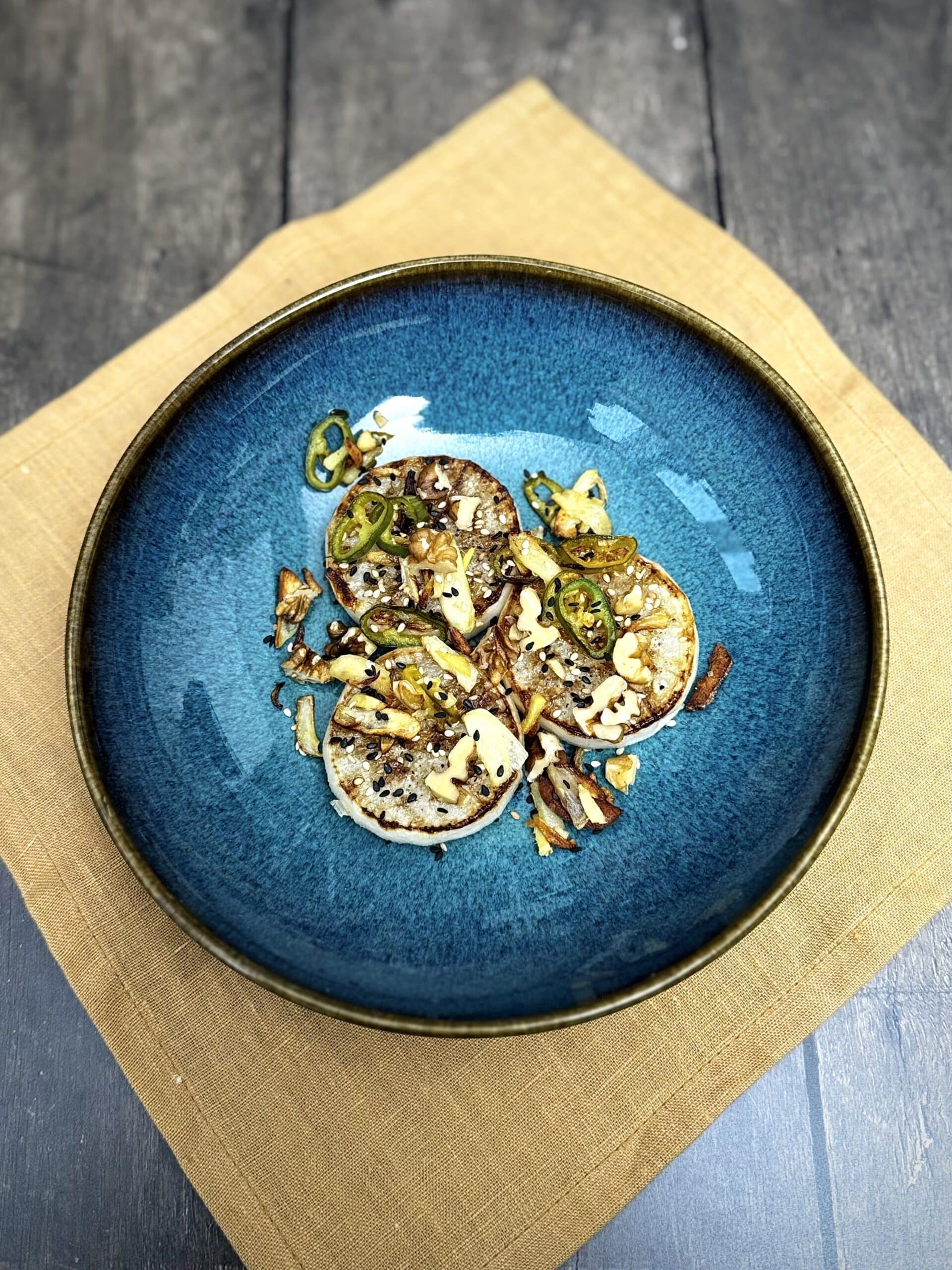 Roasted white radish with chili, garlic and nuts, topped with sesame seeds