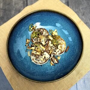 Roasted white radish with chili, garlic and nuts, topped with sesame seeds