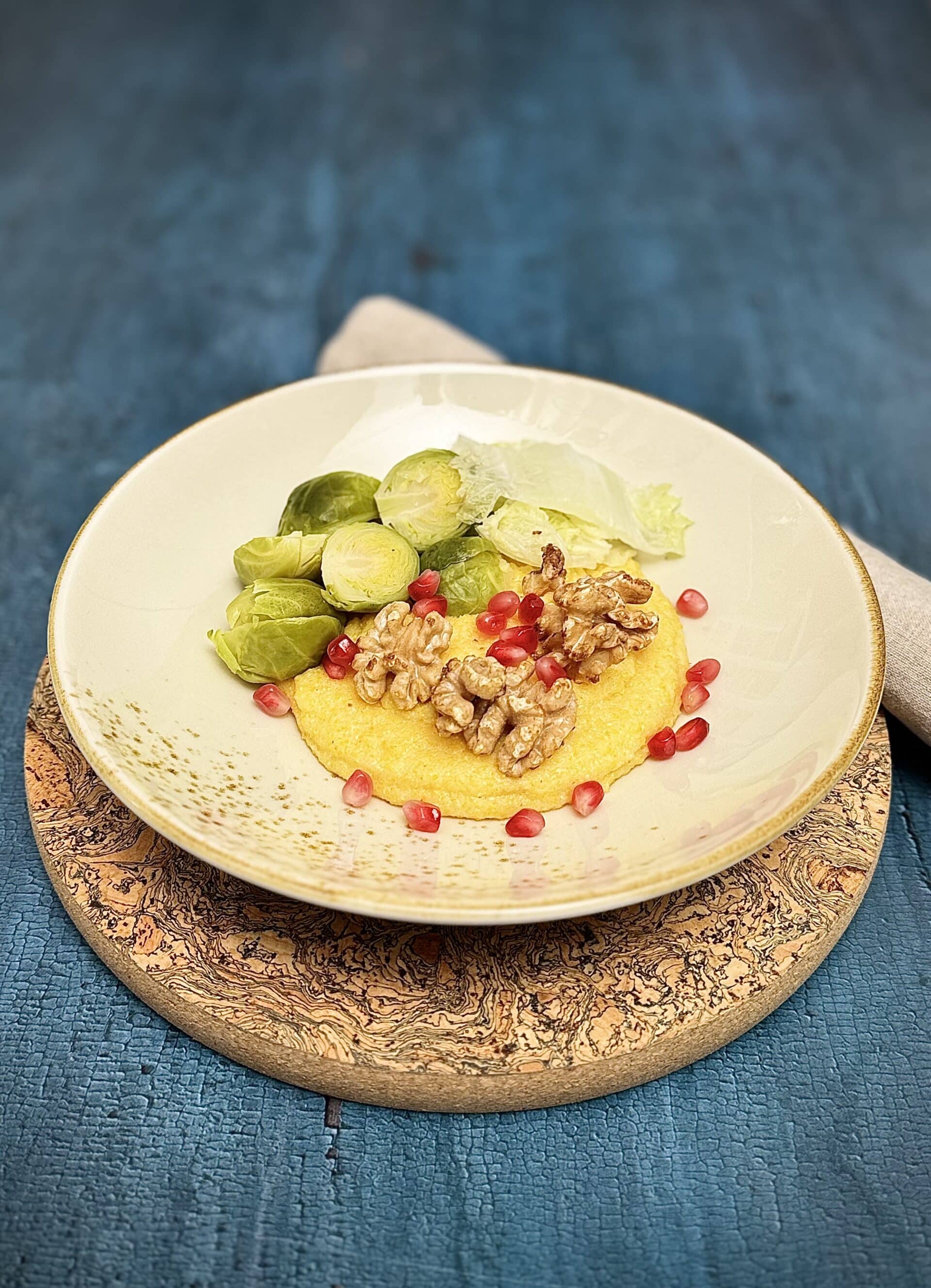 Steamed Brussels sprouts and Chinese cabbage served over creamy polenta with walnuts and pomegranate seeds.