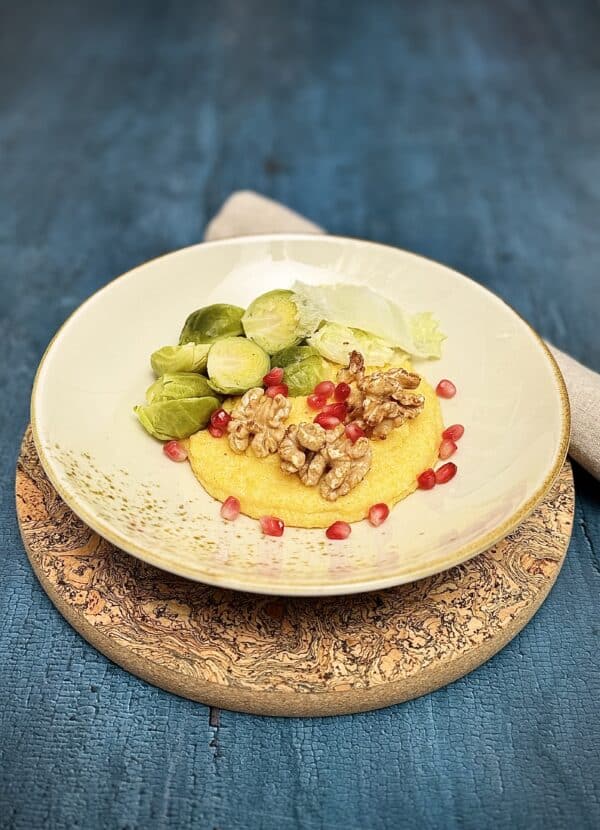 Steamed Brussels sprouts and Chinese cabbage served over creamy polenta with walnuts and pomegranate seeds.