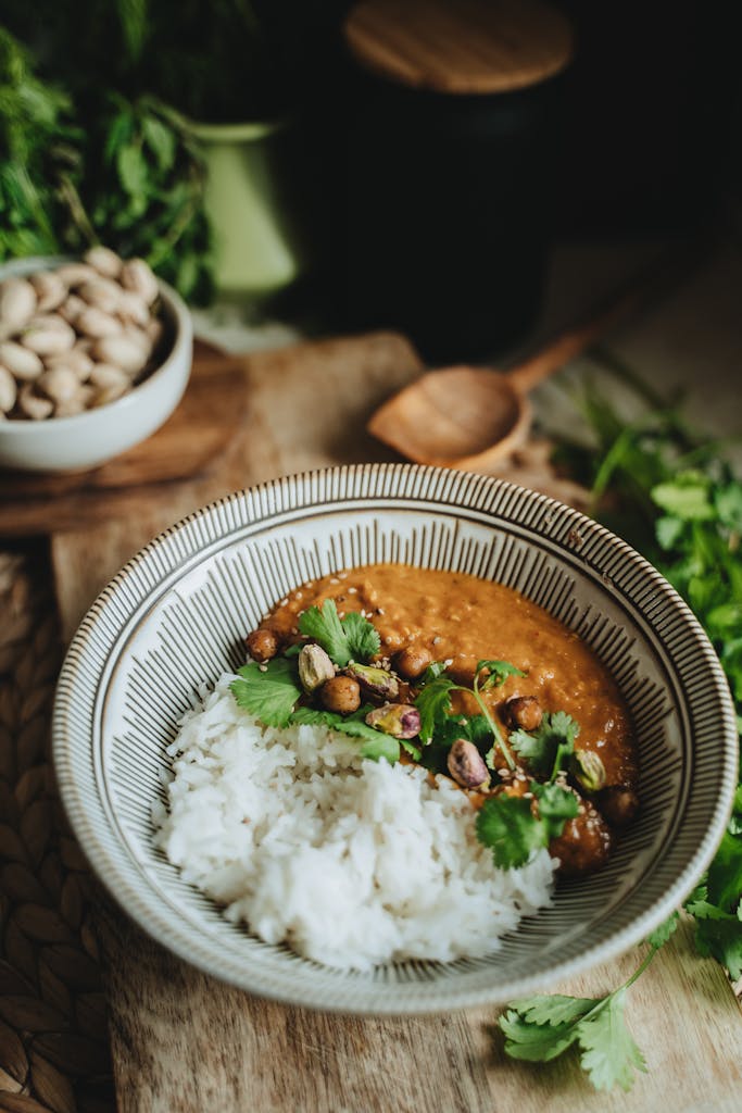 A bowl of lentil curry with rice garnished with cilantro